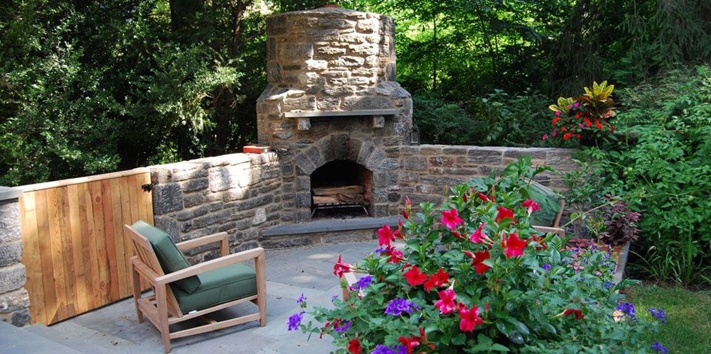 stone fireplace with flowers and lounging area
