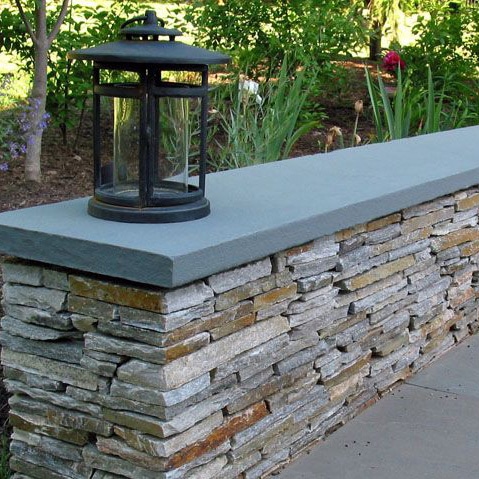 stone wall with lamp on top