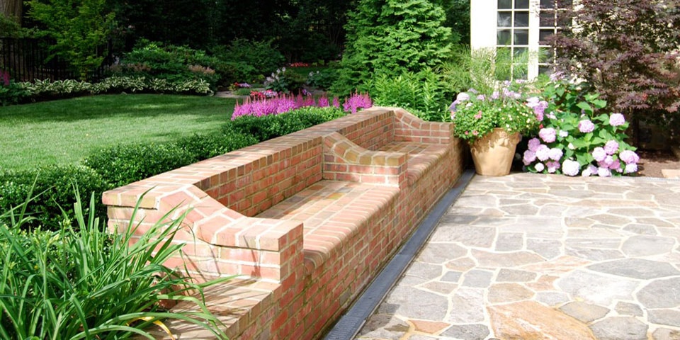brick bench with flowers